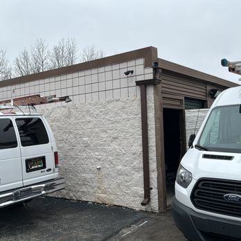 Koerber Construction & Contracting - two vans parked in front of a building - Roofing Near Me - Rochester Hills, Michigan Koerber Construction & Contracting - two vans parked in front of a building - Roofing Near Me - Rochester Hills, Michigan