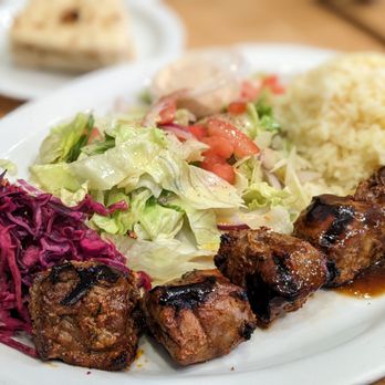 Mediterranean Kebab - Shlsh Kebab (Lamb-5 pieces) Plate with pickled cabbage, salad, mediterraneean rice. Pita bread (in background) - Turkish Near Me - Burlingame, California Mediterranean Kebab - Shlsh Kebab (Lamb-5 pieces) Plate with pickled cabbage, salad, mediterraneean rice. Pita bread (in background) - Turkish Near Me - Burlingame, California