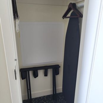Hilton Orlando - Closet area (near the door) with ironing board, hangers, and suitcase stand. - Hotels Near Me - Orlando, Florida