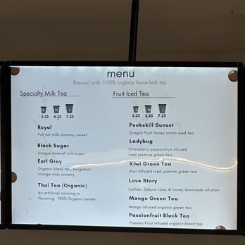 Peekskill Boba - A backlit menu board at Peekskill Boba in Peekskill, NY, lists organic tea beverages including milk teas, fruit teas, and specialty options with prices. - Bubble Tea Near Me - Peekskill, New York