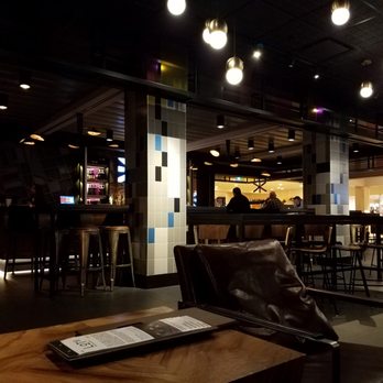 LOT 41 - a bar with leather chairs and a menu on the table - Lounges Near Me - Toronto, Ontario