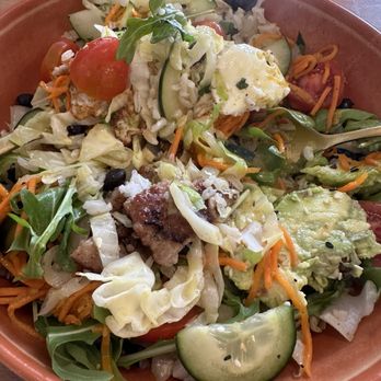 Tequesta Table - Just a mess,  no really flavor - A mixed vegetable salad featuring cucumbers, cherry tomatoes, shredded carrots, avocado, and leafy greens served in a bowl. - Breakfast & Brunch Near Me - Tequesta, Florida