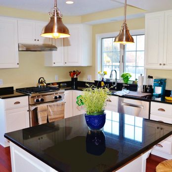 Lent Builders - a kitchen with white cabinets and black countertops - General Contractors Near Me - North Tonawanda, New York Lent Builders - a kitchen with white cabinets and black countertops - General Contractors Near Me - North Tonawanda, New York