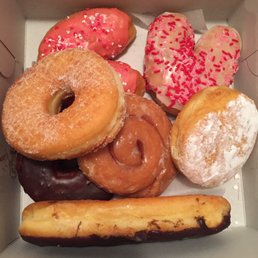 Valentine's Day Glazed w/Sprinkles, Lemon, Chocolate Bar, Cinnamon Roll, Chocolate Cake, Sugar (clockwise from top left)