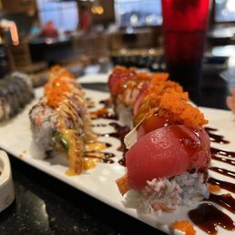 a plate of sushi and sauces a plate of sushi and sauces