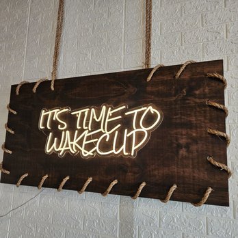 Wake Cup Astoria - a neon sign hanging on a wall - Cafes Near Me - New York, New York Wake Cup Astoria - a neon sign hanging on a wall - Cafes Near Me - New York, New York