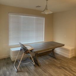 a dining room with a table and chairs
