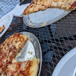 Tino's Bar & Pizza - Meat and veggie pizzas while sitting outside
