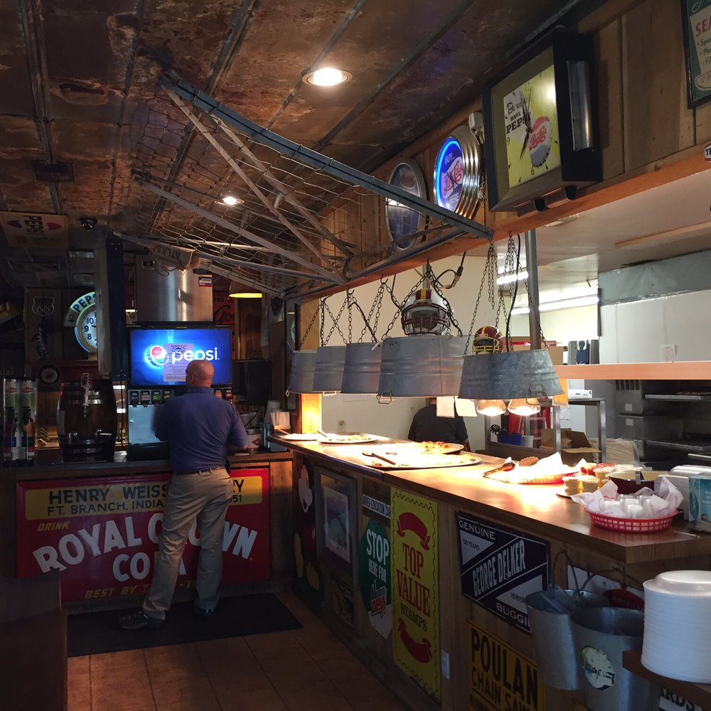 Sandy's Pizza - a man preparing food in a restaurant - Pizza Near Me - Fort Branch, Indiana Sandy's Pizza - a man preparing food in a restaurant - Pizza Near Me - Fort Branch, Indiana