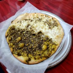 Half cheese half zaatar manakeesh (flatbread) Half cheese half zaatar manakeesh (flatbread)