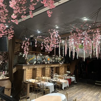 Encore - a restaurant with tables, chairs, and flowers hanging from the ceiling - New American Near Me - Brooklyn, New York Encore - a restaurant with tables, chairs, and flowers hanging from the ceiling - New American Near Me - Brooklyn, New York