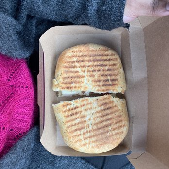 Jugo Juice - a person holding a box with a sandwich in it - Juice Bars & Smoothies Near Me - Edmonton, Alberta Jugo Juice - a person holding a box with a sandwich in it - Juice Bars & Smoothies Near Me - Edmonton, Alberta
