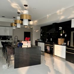 Royal Granite & Marble - Full wall backsplash, countertops, and a waterfall edge in sleek black granite takes this client's kitchen to the next level!