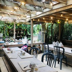 Clayworks At Kilohana - Full studio pic, outdoor & covered in flowers and garden.