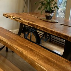 Reclaimed - Custom designed live edge acacia dining table on crank base with bench on our custom anchor legs.