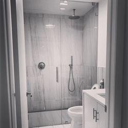 Elliot Glass & Mirror - 1/2" thick full height panel secured with clamps, 80" 3/8" thick door.