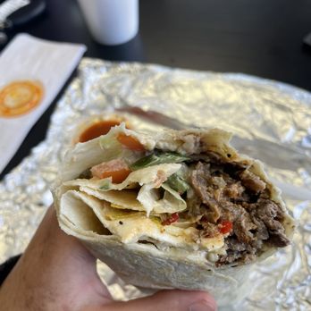 Falafel Cafe - a hand holding a burrito - Falafel Near Me - Birmingham, Alabama