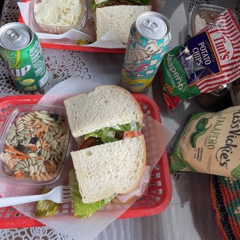 Loose Caboose - a sandwich, salad, and soda on a table - Sandwiches Near Me - Salinas, California Loose Caboose - a sandwich, salad, and soda on a table - Sandwiches Near Me - Salinas, California
