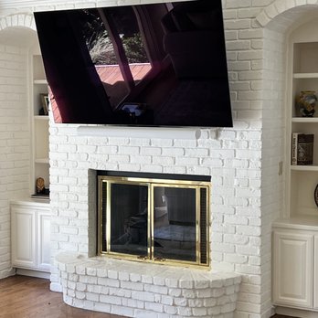 The Floating TV - Installation of 110v outlet behind TV, bracket, 77" TV, outlet inside cabinet, and running CAT5 and HDMI from cabinet to TV. - Home Theatre Installation Near Me
