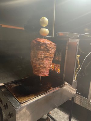 Photo of Erick El Taquero - Santa Ana, CA, US. a kebab being cooked