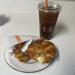 Dunkin' - Medium ice coffee, sausage egg and cheese on croissant with potato bites. Six dollars meal deal