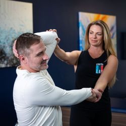 Relieve neck tension and improve upper body mobility with a 1-on-1 assisted cross-body stretch at StretchLab.