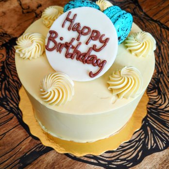 MacaronZ - Custom birthday cake with vanilla buttercream frosting in pastel yellow. - Desserts Near Me - Brampton, Ontario