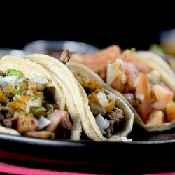 Fiesta Taco - Plated with love just like our parents taught us, these Buche Asada Tacos feature tender buche and juicy asada piled high on fresh corn tort