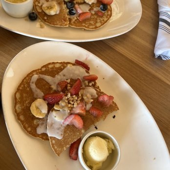Duke's Malibu - Banana & Mac Nut Pancakes split in half - New American Near Me - Malibu, California Duke's Malibu - Banana & Mac Nut Pancakes split in half - New American Near Me - Malibu, California