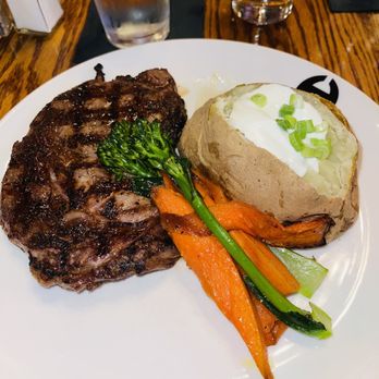 Hamley Steakhouse & Saloon - 14 ounce ribeye with a big potato and vegetables - Steakhouses Near Me - Pendleton, Oregon