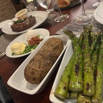Stockman's Steakhouse - 22 oz bone in ribeye with bearnaise sauce. 8 oz filet with blue cheese crust. Grilled asparagus and baked potato! Delish! - Steakhouses Near Me - Laughlin, Nevada Stockman's Steakhouse - 22 oz bone in ribeye with bearnaise sauce. 8 oz filet with blue cheese crust. Grilled asparagus and baked potato! Delish! - Steakhouses Near Me - Laughlin, Nevada