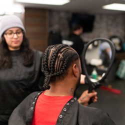 The Village Barbershop - Rosie the barber with  finished braids