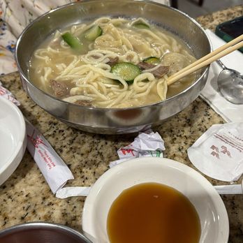 Gogiya - Noodles and dumplings in beef broth with vegetables. - Korean Near Me - Bossier City, Louisiana Gogiya - Noodles and dumplings in beef broth with vegetables. - Korean Near Me - Bossier City, Louisiana