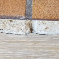 Bass Family Flooring - The hardwood floor was scribed to fit the rough brick surface.