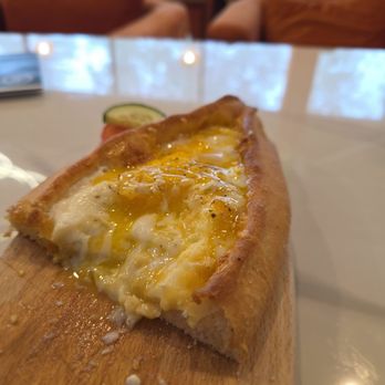 The Hanging Gardens Cafe - Half-eaten egg and cheese pide :p - Coffee & Tea Near Me - Vienna, Virginia