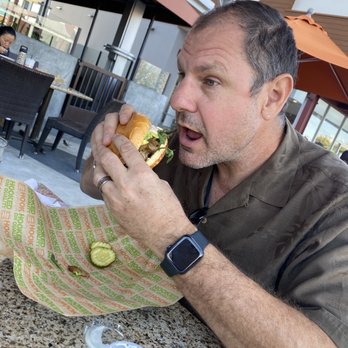 Hook Burger - Hubby taking his first bite! - Burgers Near Me - Burbank, California