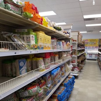 Asian Supermarket - Aisles of dry food like noodles, wraps, canned goods, condiments, beans, tea, etc.  Shelf kinda 'empty' perhaps due to Lunar New Year - Imported Food Near Me - Greenville, South Carolina