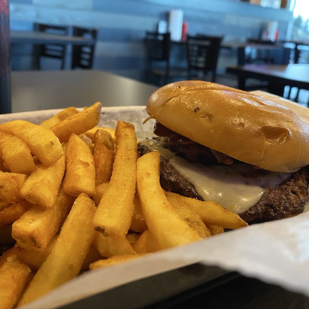 Motley Que burger with fries. Motley Que burger with fries.