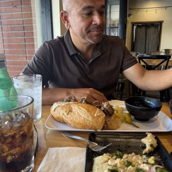 Nosh Bar - Enjoying his Italian Beef Sandwich - Bars Near Me - Costa Mesa, California Nosh Bar - Enjoying his Italian Beef Sandwich - Bars Near Me - Costa Mesa, California