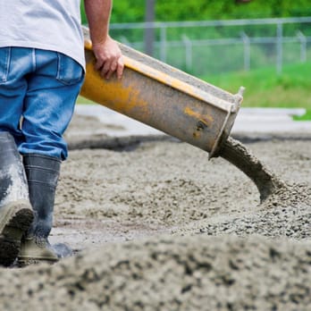 StoneTech - a man pouring concrete with a shovel - General Contractors Near Me - Atascadero, California StoneTech - a man pouring concrete with a shovel - General Contractors Near Me - Atascadero, California