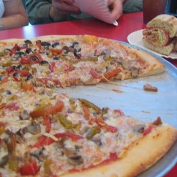 Florio's Pizza - Italian sandwich in the background is the best! - Pizza Near Me - San Antonio, Texas Florio's Pizza - Italian sandwich in the background is the best! - Pizza Near Me - San Antonio, Texas