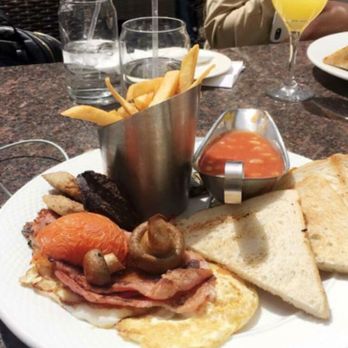 Playwright Celtic Pub - The Traditional Irish Breakfast with ham, sausage, eggs, mushrooms, a side of beans, and french fries for brunch. Also with a mimosa - New American Near Me - New York, New York Playwright Celtic Pub - The Traditional Irish Breakfast with ham, sausage, eggs, mushrooms, a side of beans, and french fries for brunch. Also with a mimosa - New American Near Me - New York, New York