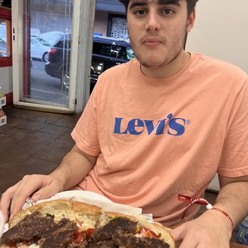 Garden Halal Meat - A local enjoying a delicious kofta kebab sub - African Near Me - Boston, Massachusetts