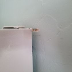 Prescott Cabin Rentals - Damage to kitchen wall apparently by fridge.