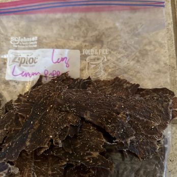Sena's Beef Jerky - A clear Ziploc bag with a pink and blue zipper seal holds dried beef jerky pieces on a countertop. - Specialty Food Near Me - Albuquerque, New Mexico
