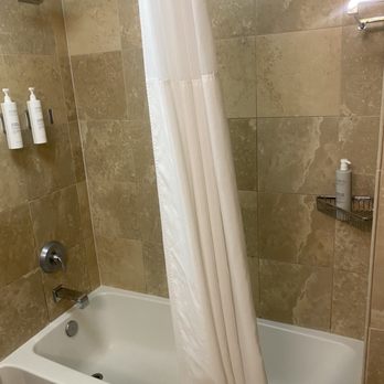 Hampton Inn & Suites Jackson - Clean and large bath tub with rainfall shower head and supplies. - Hotels Near Me - Jackson, Tennessee
