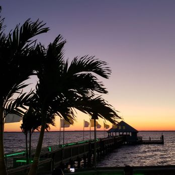 Sunset Grille & Raw Bar - a dock and palm trees - Sushi Bars Near Me - Duck, North Carolina