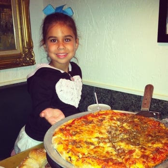 Angelo's - My niece showing off one of Angelo's delicious pizzas. - Pizza Near Me - Jupiter, Florida