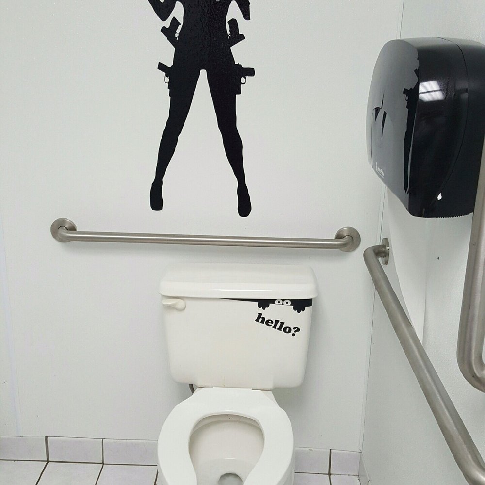 Mack's Tavern - a woman with a gun on a toilet - Dive Bars Near Me - Dayton, Ohio