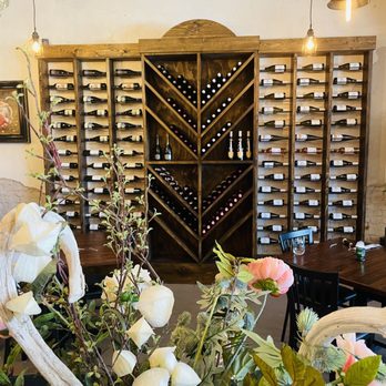 Fontina Ristorante - a wine rack and flowers - Italian Near Me - McKinney, Texas Fontina Ristorante - a wine rack and flowers - Italian Near Me - McKinney, Texas